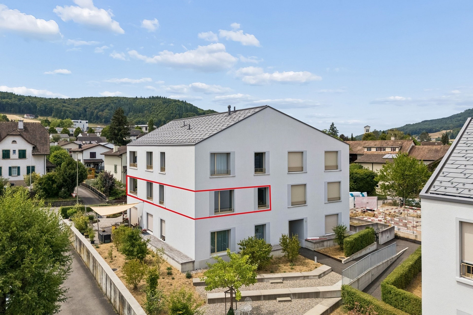 Mehrfamilienhaus in Hanglage mit markiertem Gebäudeteil