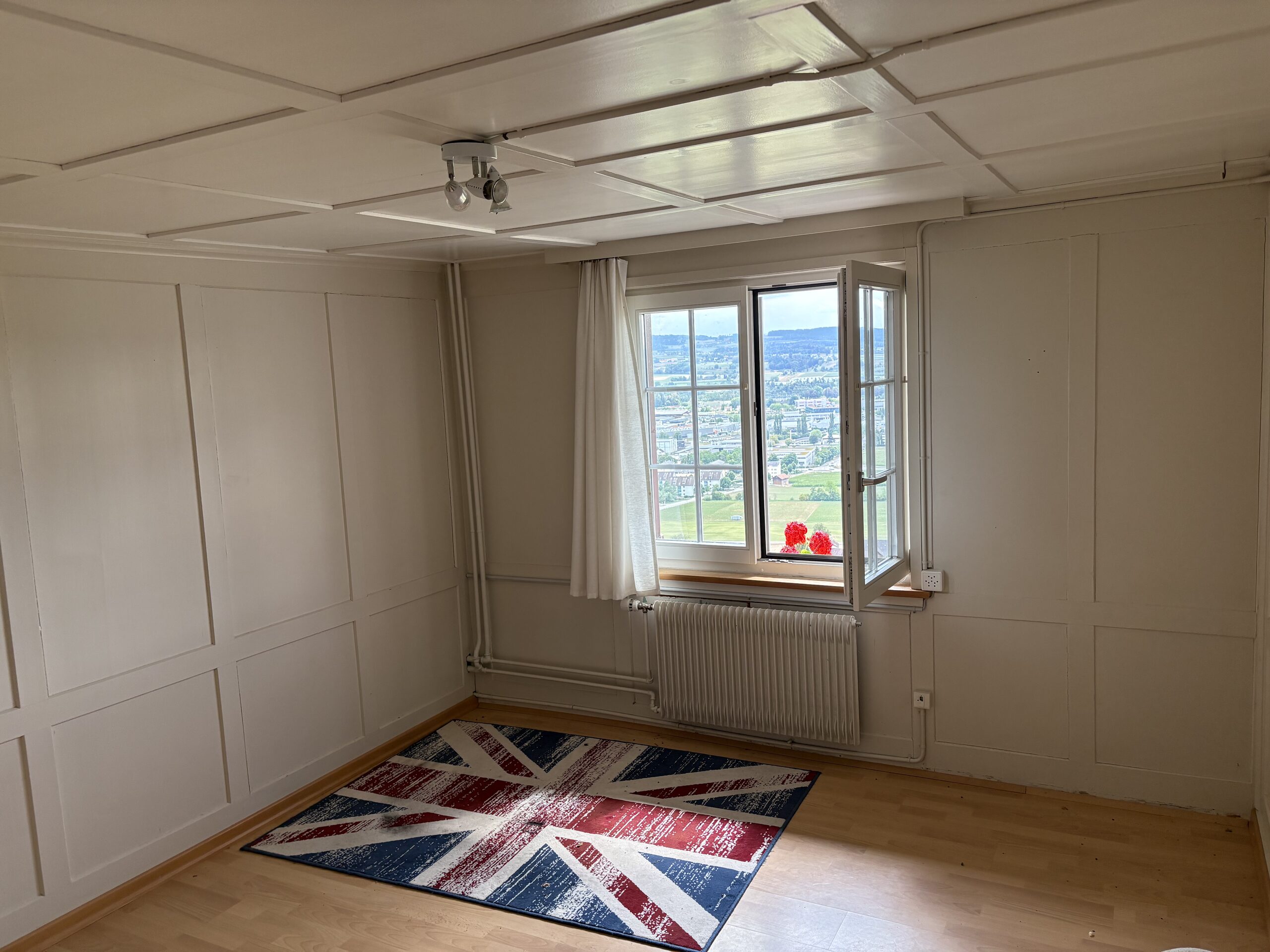 Helles Zimmer mit Ausblick und Union-Jack-Teppich