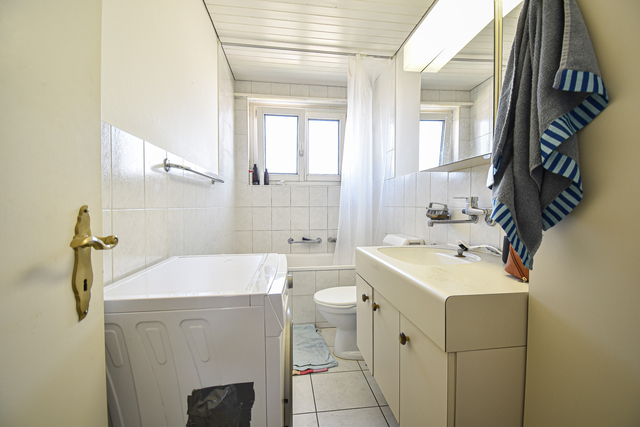 Kleines Badezimmer mit Badewanne und Fenster